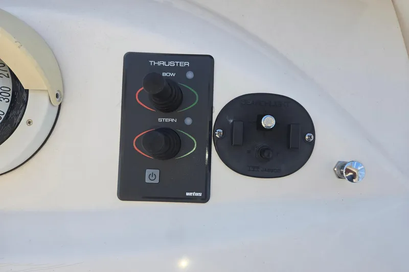 Slide: The Image of Control panel on a 2003 Silverton 392 Motor Yacht, featuring thruster and searchlight controls. - 24