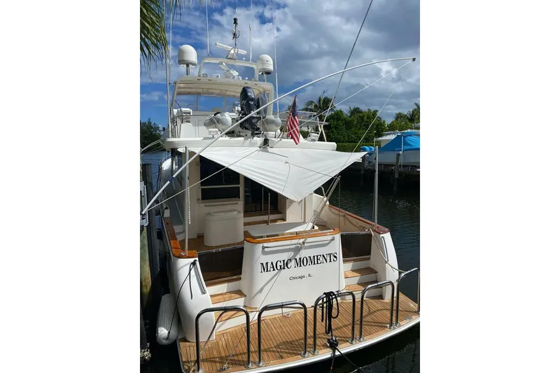 Slide: The Image of 2006 North Star Yachts 73 Cockpit Motoryacht docked, rear view with canopy and American flag. - 11