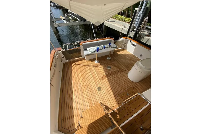 Slide: The Image of Luxurious teak deck of 2006 North Star Yachts 73 Cockpit Motoryacht, featuring elegant seating. - 13