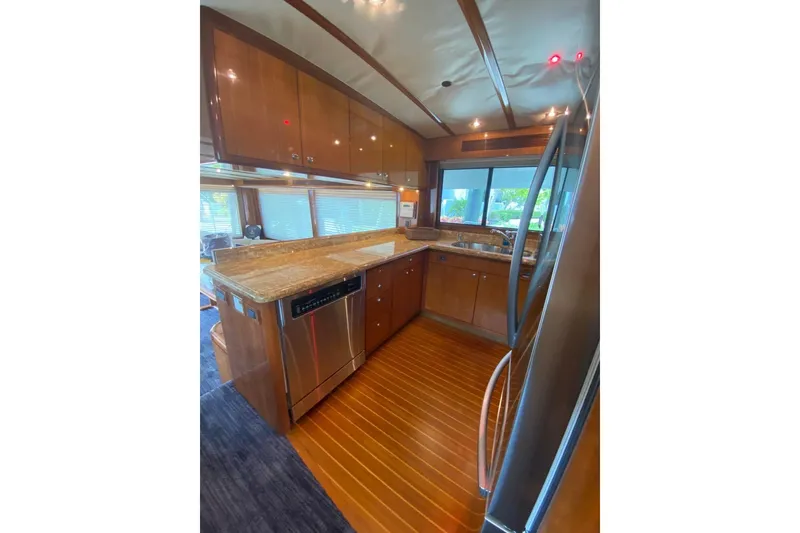 Slide: The Image of Luxurious kitchen interior of 2006 North Star Yachts 73 Cockpit Motoryacht with wood cabinetry. - 15