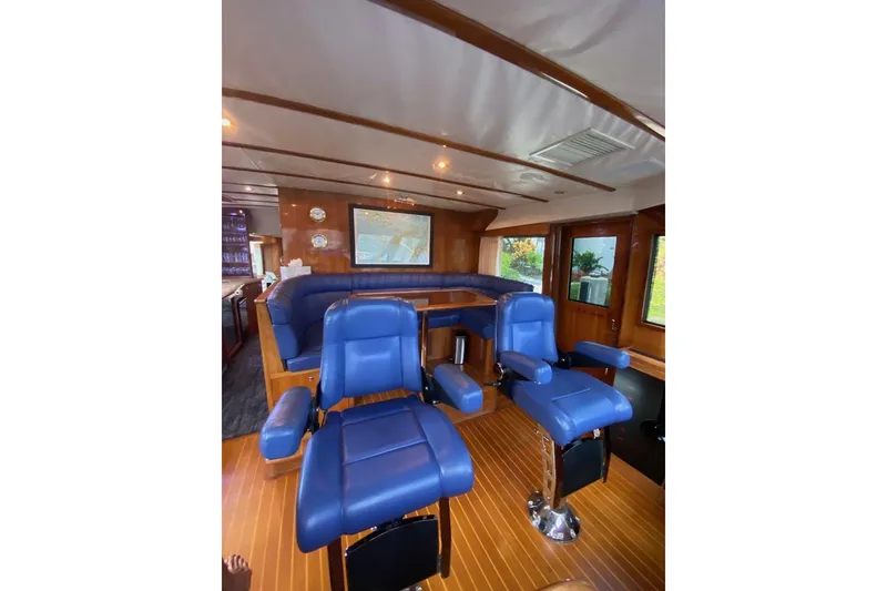 Slide: The Image of Luxurious interior of 2006 North Star Yachts 73 Cockpit Motoryacht with blue seating and wood accents. - 16