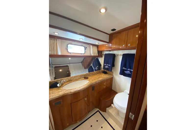 Slide: The Image of Luxurious bathroom in 2006 North Star Yachts 73 Cockpit Motoryacht with wood cabinetry and marble countertop. - 22