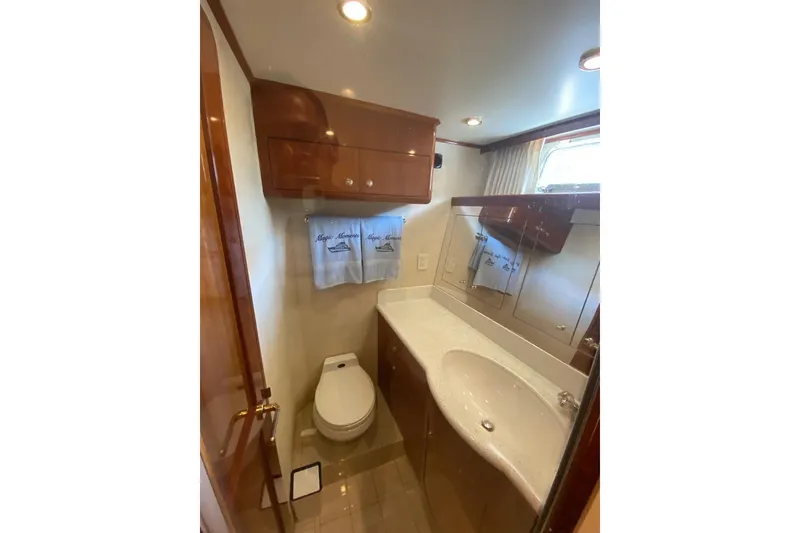 Slide: The Image of Luxurious bathroom in 2006 North Star Yachts 73 Cockpit Motoryacht, featuring elegant wood cabinetry. - 26