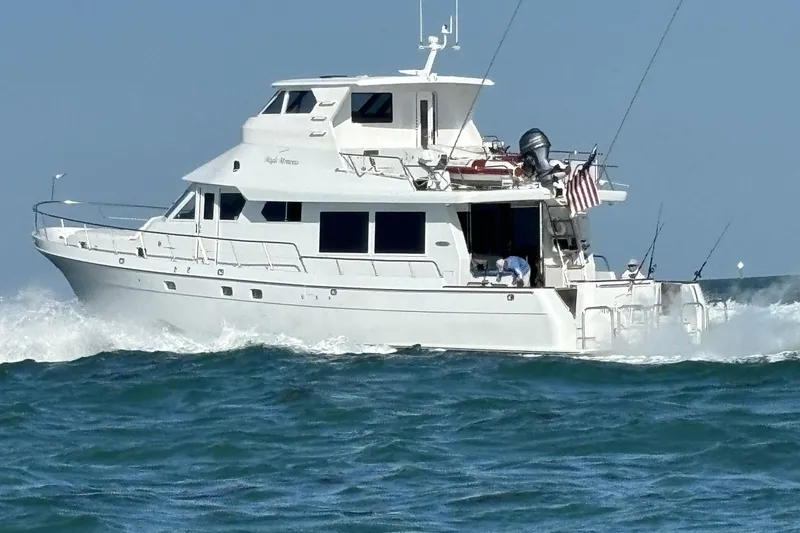 Slide: The Image of Northstar 73 Cockpit Motoryacht 2006 cruising on open water, displaying sleek design and power. - 3