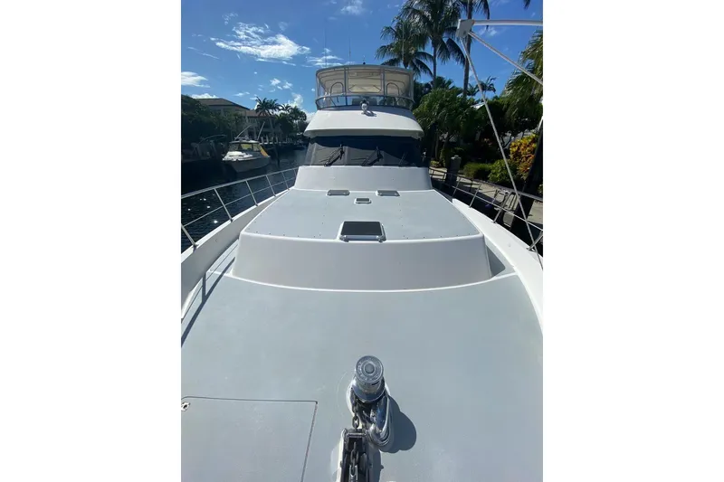 Slide: The Image of 2006 North Star Yachts 73 Cockpit Motoryacht docked, showcasing sleek deck design. - 32