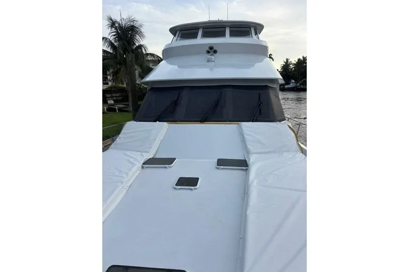 Slide: The Image of 2006 North Star Yachts 73 Cockpit Motoryacht, docked with covered deck, palm trees in background. - 46