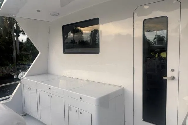 Slide: The Image of 2006 North Star Yachts 73 Cockpit Motoryacht, sleek white exterior with window and door. - 55