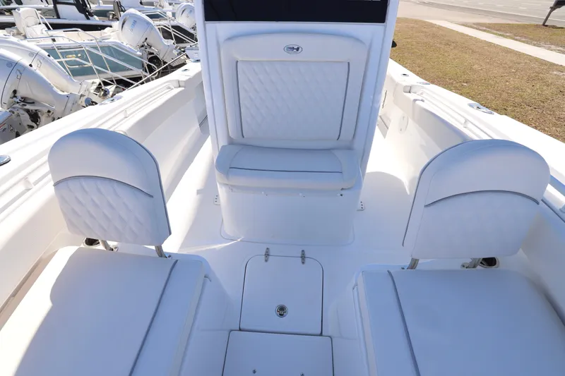 Slide: The Image of 2026 Sea Hunt Gamefish 25 boat interior with white cushioned seating. - 12
