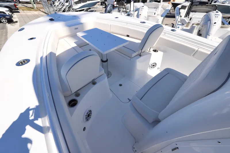 Slide: The Image of 2026 Sea Hunt Gamefish 25 boat interior with seating and table, showcasing modern design. - 13