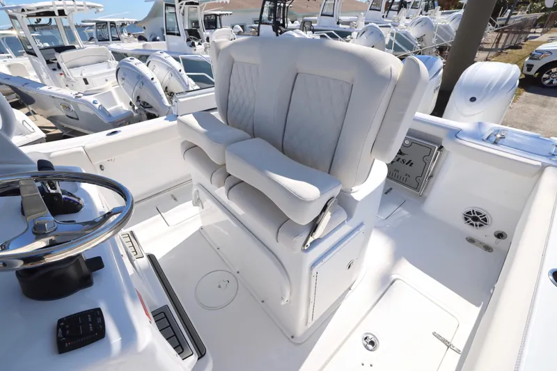 Slide: The Image of 2026 Sea Hunt Gamefish 25 boat interior with helm and seating. - 18