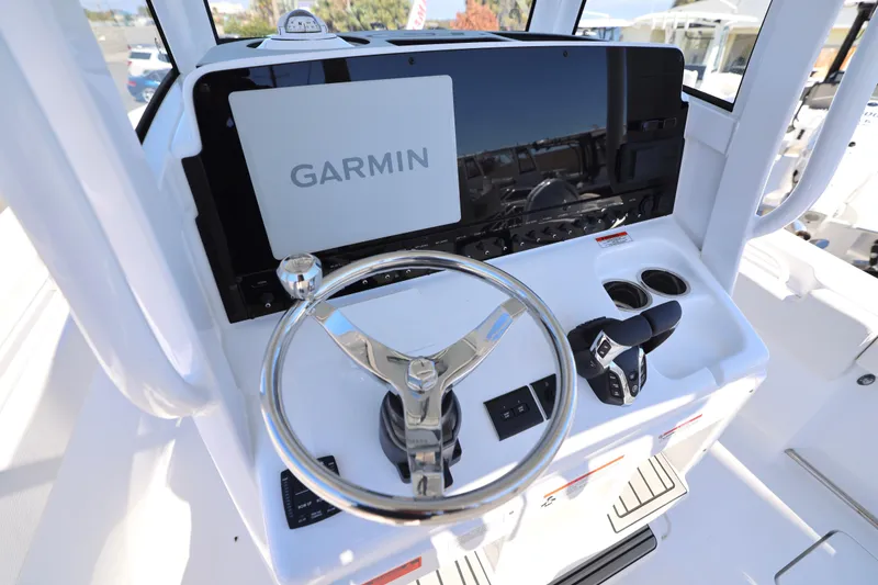 Slide: The Image of 2026 Sea Hunt Gamefish 25 helm with Garmin display and steering wheel. - 22