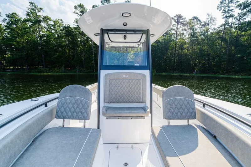 Slide: The Image of Manufacturer Provided Image: 2026 Sea Hunt Gamefish 25 boat interior with cushioned seating, set against a serene lake backdrop. - 28