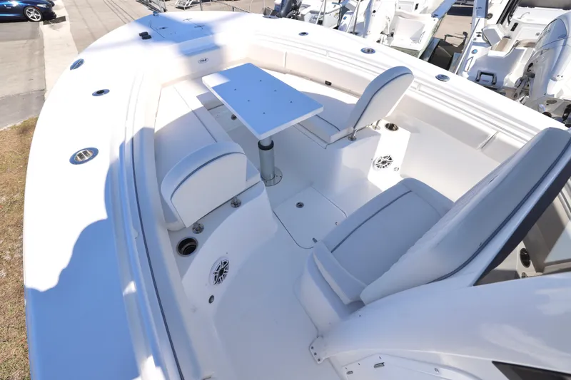 Slide: The Image of 2026 Sea Hunt Gamefish 25 boat interior with seating and table setup. - 3