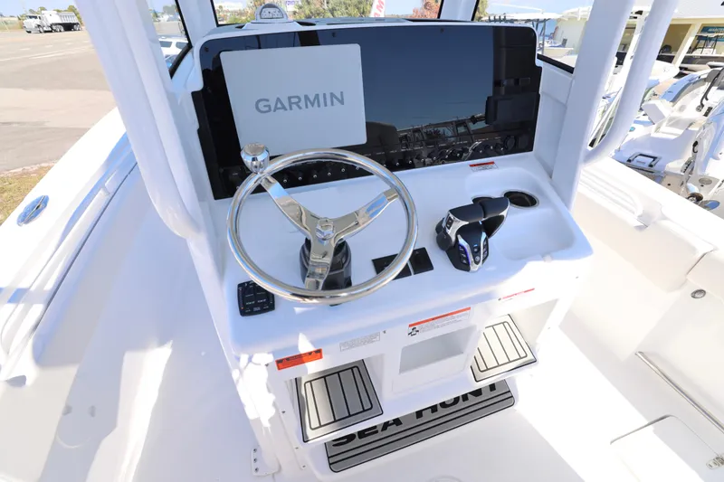 Slide: The Image of 2026 Sea Hunt Gamefish 25 helm with Garmin display and steering wheel. - 4