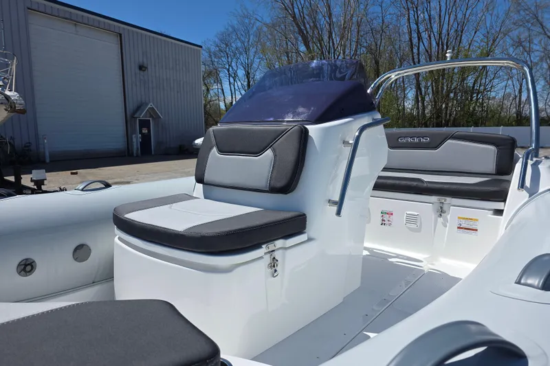 Slide: The Image of 2026 Grand Inflatables G500 boat interior with sleek seating and modern design. - 7