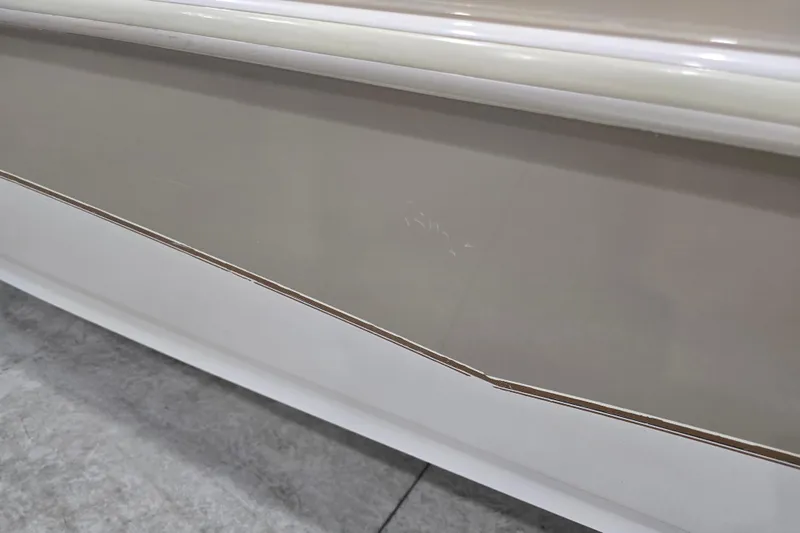 Slide: The Image of Close-up of 1996 Larson LXi 218 boat hull with beige and white detailing. - 14