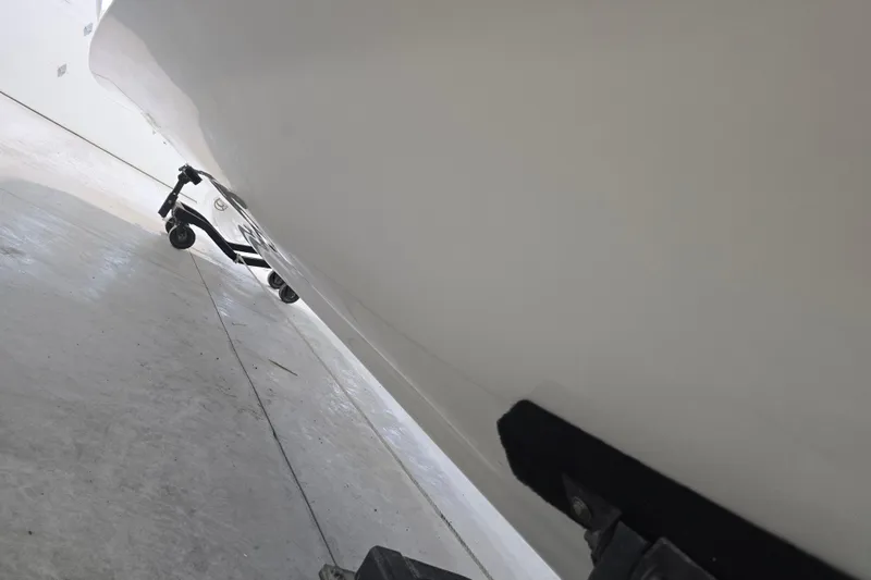 Slide: The Image of 1996 Larson LXi 218 boat hull on trailer in storage facility. - 16