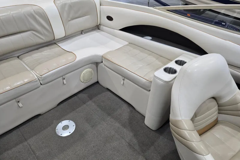 Slide: The Image of Interior of 1996 Larson LXi 218 boat with beige seating and cup holders. - 20