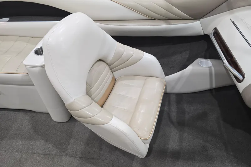 Slide: The Image of 1996 Larson LXi 218 boat interior with white leather seating and cup holder. - 21