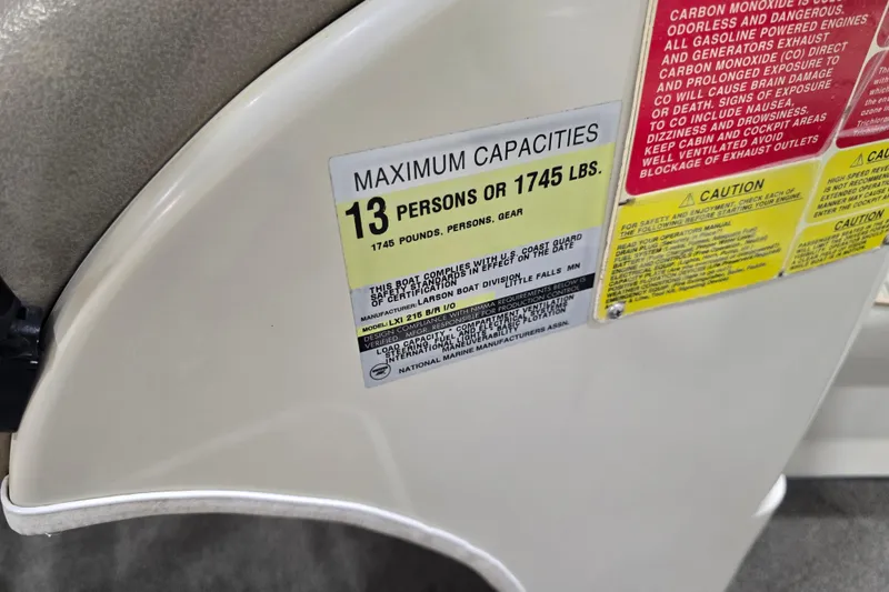 Slide: The Image of 1996 Larson LXi 218 capacity label: 13 persons or 1745 lbs, safety warnings included. - 24
