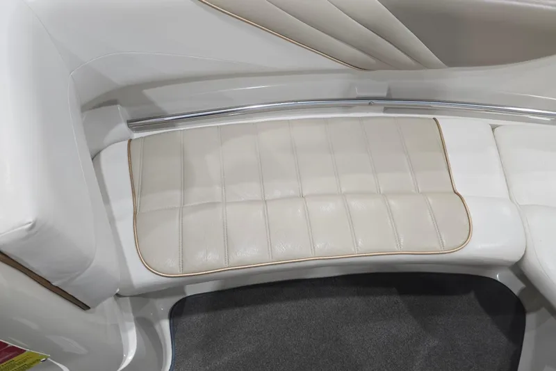 Slide: The Image of 1996 Larson LXi 218 boat interior with beige cushioned seating. - 25
