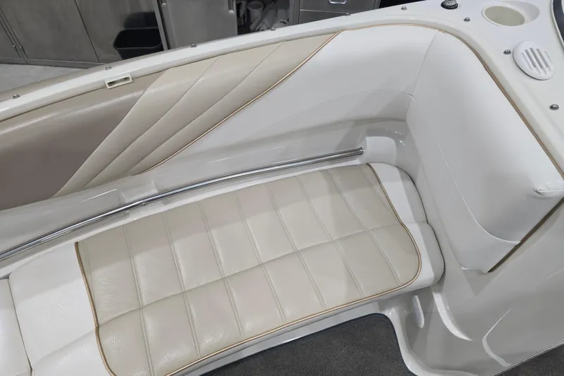 Slide: The Image of 1996 Larson LXi 218 boat interior with beige leather seating and chrome accents. - 27