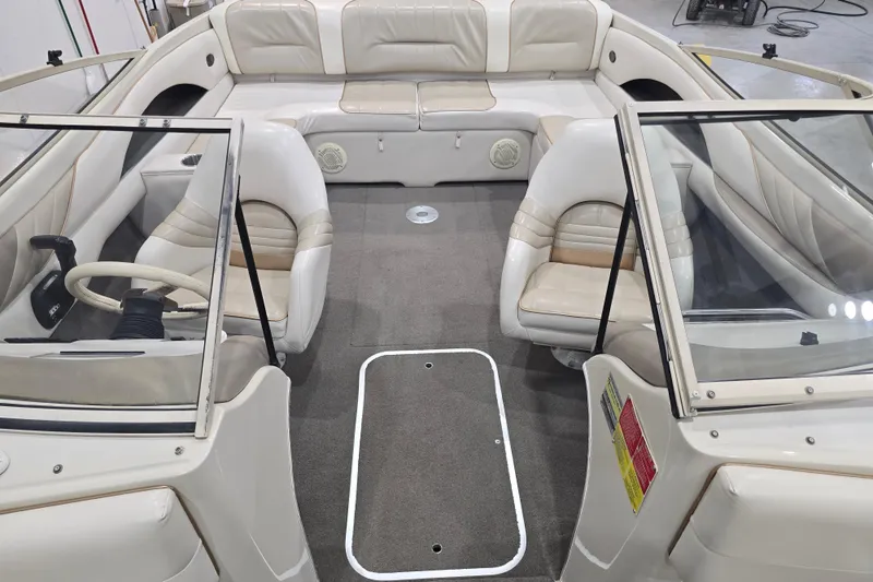 Slide: The Image of 1996 Larson LXi 218 boat interior with beige seating and steering wheel. - 28