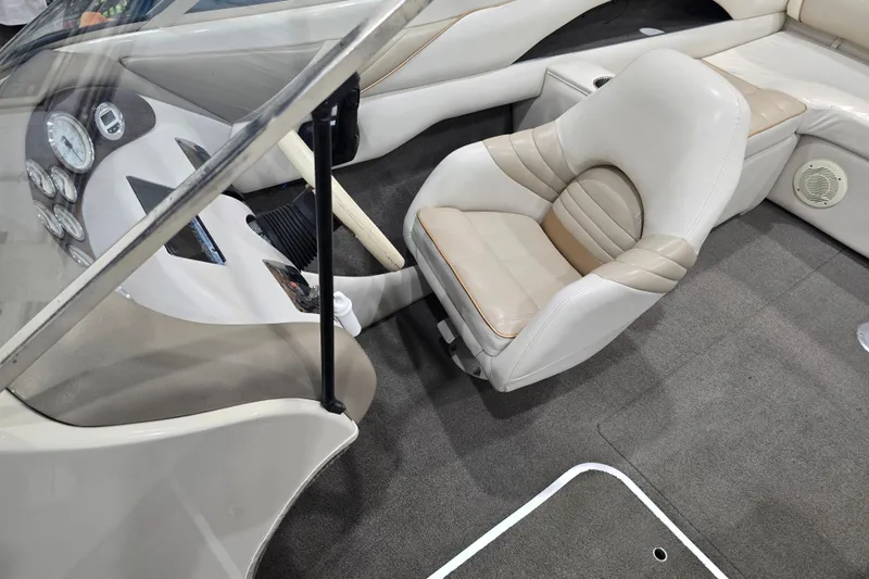Slide: The Image of Interior of 1996 Larson LXi 218 boat with beige seating and dashboard controls. - 29