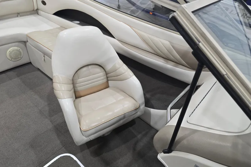 Slide: The Image of Interior of a 1996 Larson LXi 218 boat with white leather seating and carpeted floor. - 30