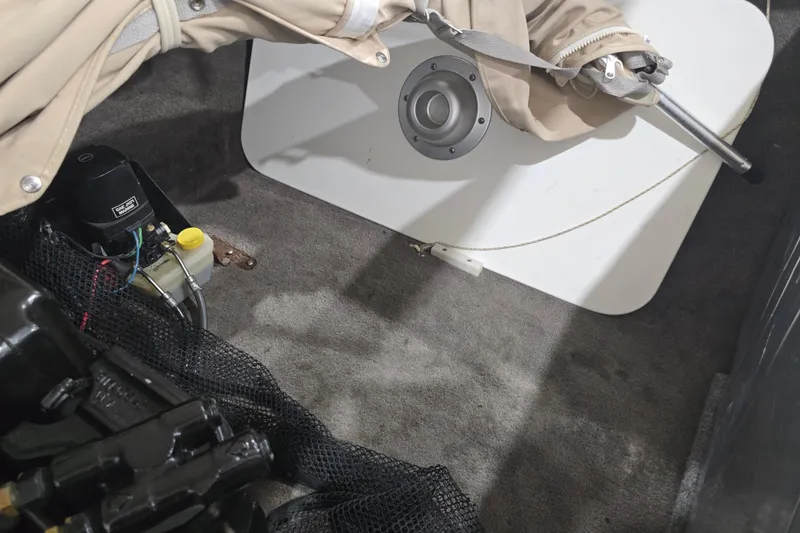 Slide: The Image of Interior view of a 1996 Larson LXi 218 boat showing mechanical components and storage area. - 35