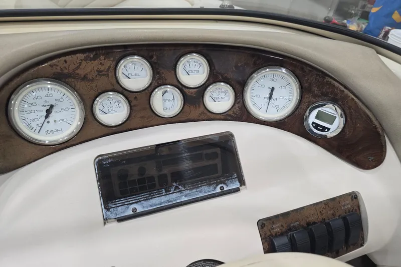 Slide: The Image of 1996 Larson LXi 218 dashboard with gauges and controls, featuring speedometer and RPM indicators. - 36