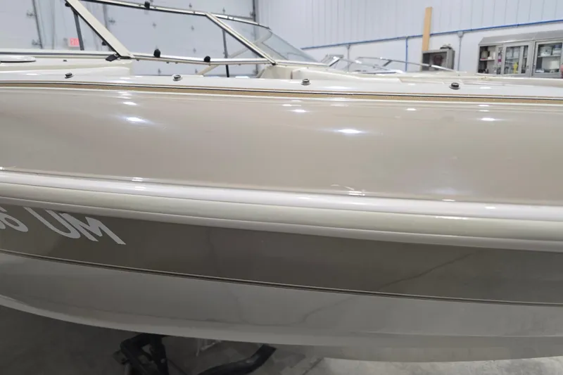 Slide: The Image of 1996 Larson LXi 218 boat side view in indoor storage facility. - 4