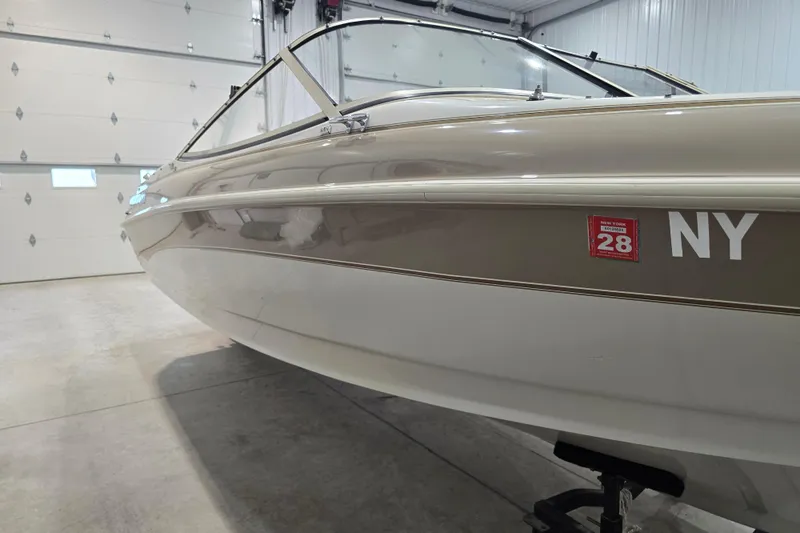 Slide: The Image of 1996 Larson LXi 218 boat in garage, New York registration visible. - 5