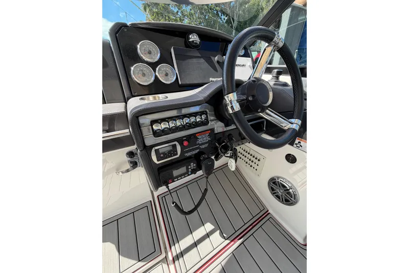 Slide: The Image of 2020 Formula 330 Crossover Bowrider OB dashboard with steering wheel and control panel. - 11