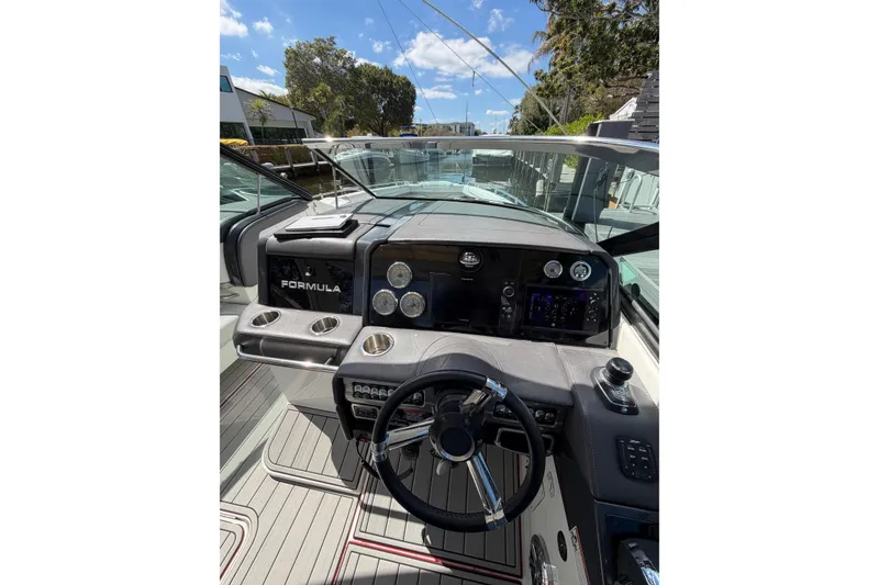 Slide: The Image of 2020 Formula 330 Crossover Bowrider OB dashboard with steering wheel and controls. - 12
