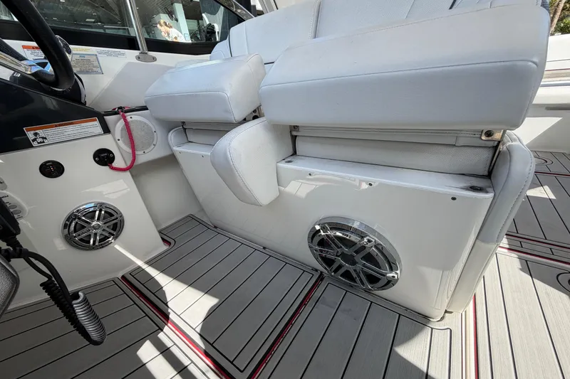 Slide: The Image of 2020 Formula 330 Crossover Bowrider OB interior with white seating and speaker system. - 14