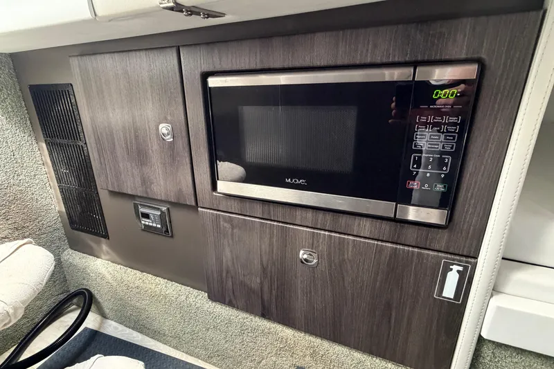 Slide: The Image of 2020 Formula 330 Crossover Bowrider OB interior with built-in microwave and storage cabinets. - 19