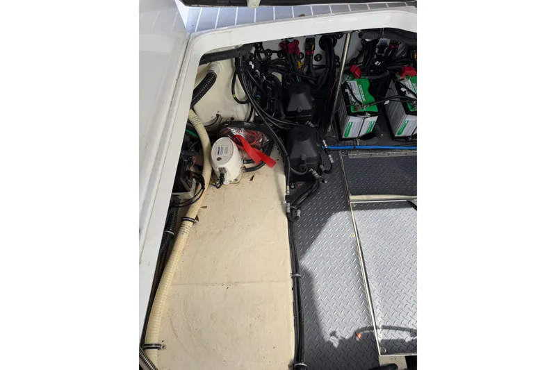 Slide: The Image of Engine compartment of a 2020 Formula 330 Crossover Bowrider OB with batteries and wiring. - 24