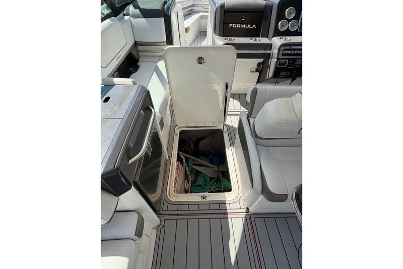 Slide: The Image of 2020 Formula 330 Crossover Bowrider OB interior with open storage compartment. - 27