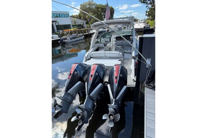 Slide: The Image of 2020 Formula 330 Crossover Bowrider OB with triple outboard engines docked. - 3