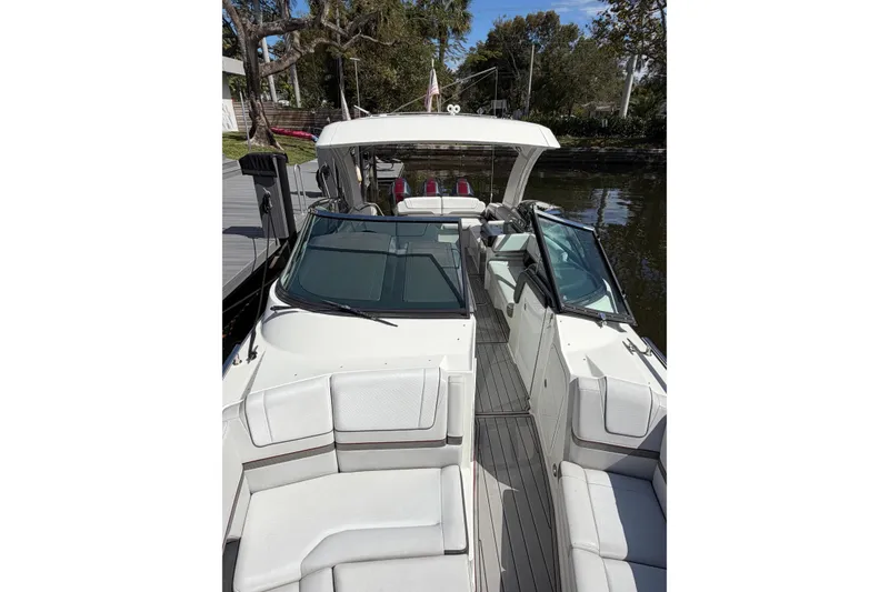 Slide: The Image of 2020 Formula 330 Crossover Bowrider OB, sleek design, docked on calm water. - 8