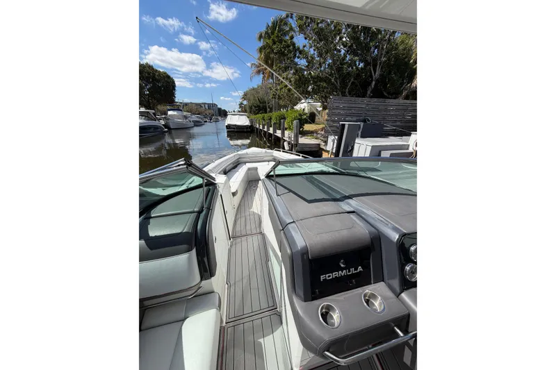 Slide: The Image of 2020 Formula 330 Crossover Bowrider OB interior, docked in a scenic marina. - 9