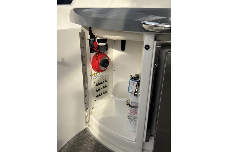 Slide: The Image of 2016 Formula 34 Performance Cruiser interior storage with safety equipment and control panel. - 12