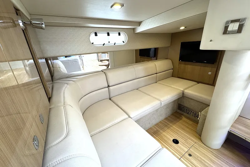 Slide: The Image of Luxurious interior of 2016 Formula 34 Performance Cruiser with beige seating and wood accents. - 20
