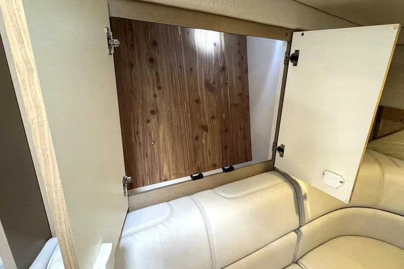 Slide: The Image of 2016 Formula 34 Performance Cruiser interior storage compartment with open cabinet doors. - 26