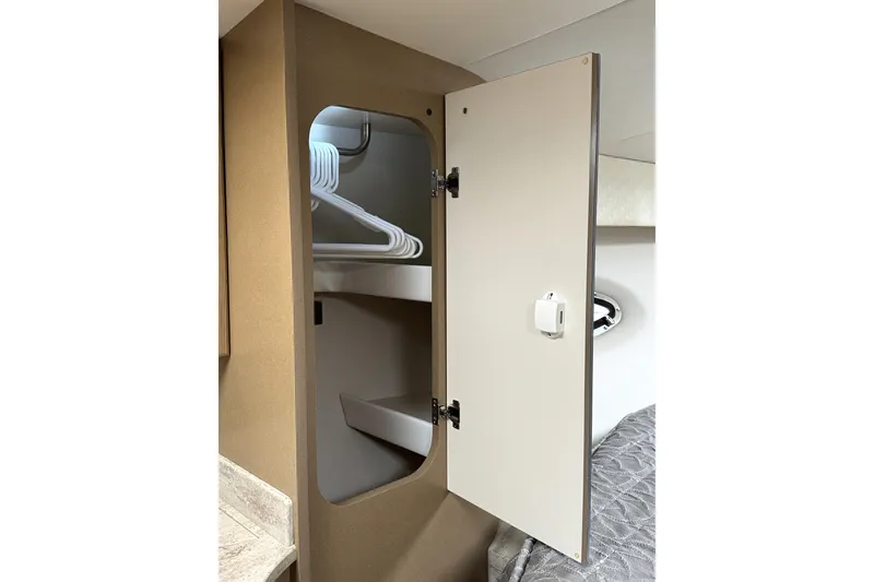 Slide: The Image of 2016 Formula 34 Performance Cruiser interior closet with hangers and open door. - 28
