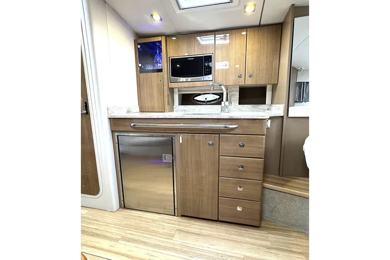 Slide: The Image of 2016 Formula 34 Performance Cruiser interior kitchen with wood cabinets and modern appliances. - 29