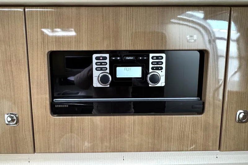 Slide: The Image of Built-in stereo system in 2016 Formula 34 Performance Cruiser, featuring wood paneling and Samsung components. - 31