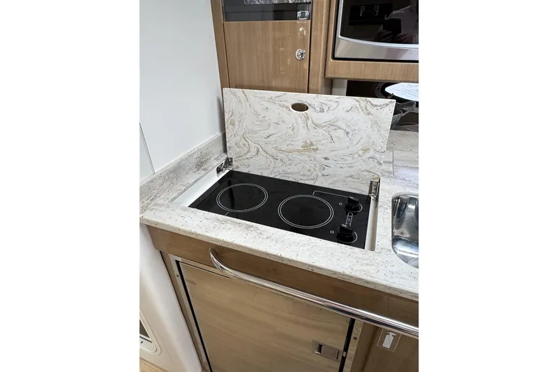 Slide: The Image of 2016 Formula 34 Performance Cruiser kitchen with electric stove and marble countertop. - 32