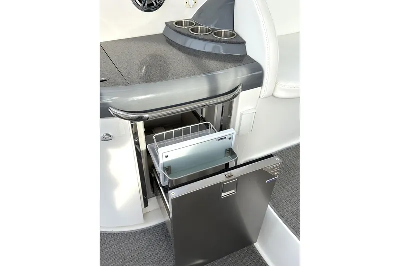 Slide: The Image of 2016 Formula 34 Performance Cruiser interior with open mini fridge and cup holders. - 6